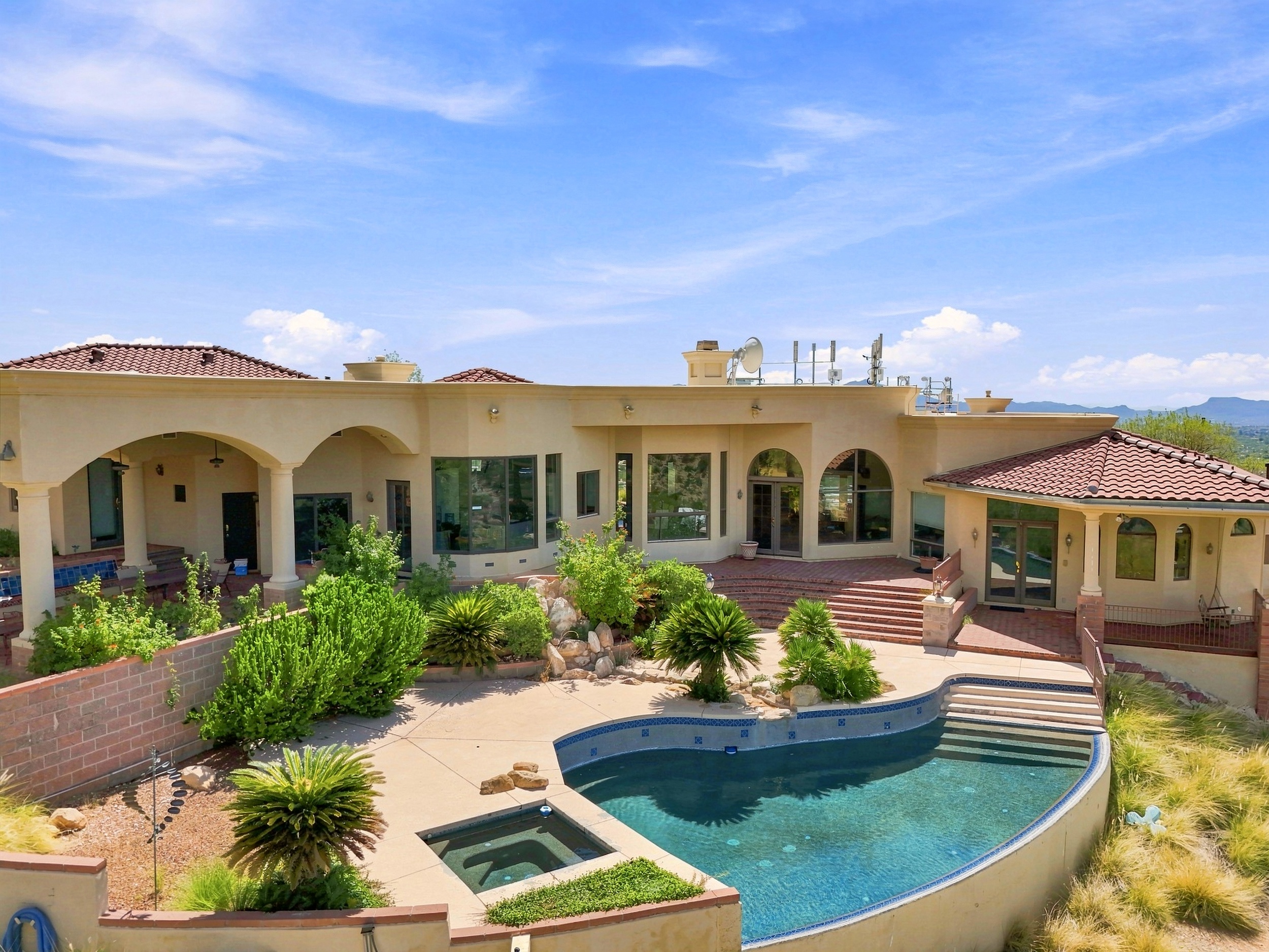 Heated infinity pool and outdoor living area surrounded by Tucson foothills and Sonoran Desert